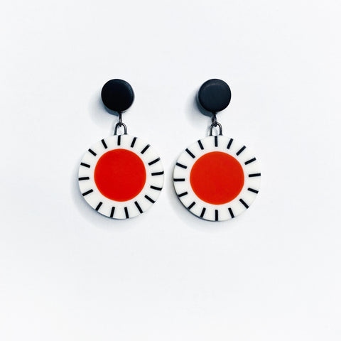 Orange, black and white Dangle Resin Earrings hung on black studs