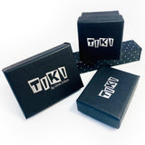 Presentation of different sizes of Tiki black gift box, embossed with the Tiki logo in silver.