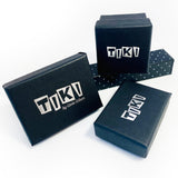 Selection of black gift boxes embossed with the Tiki logo in silver.