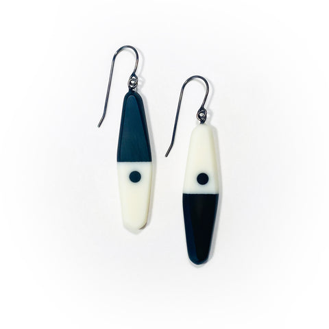 asymmetrical long diamond shaped earrings in a minimalist design of black and white resin. Hung on oxidised sterling silver.