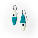 asymmetrical long diamond shaped earrings in a minimalist design of teal, black and white resin. Hung on oxidised sterling silver.