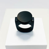 black resin finger ring fitted with a minimalist black disc