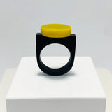 black resin finger ring fitted with a minimalist lime green disc