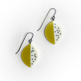 Pair of leaf shaped earrings with green and white half-half design on a white background