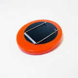Back of the sculptural oversized orange resin brooch. Fitted with sturdy surgical steel pin.