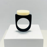 black resin finger ring fitted with a minimalist white disc
