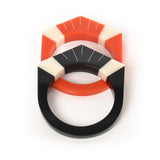 2 Art Deco resin bracelets laying, one in orange, the other in black. Both are inlaid with Deco style motif in ivory white.