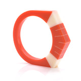 Art Deco style bracelet cast in tangerine orange resin and inlaid with Sun Ray pattern ivory white.
