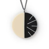 Modernist circular pendant cast in black and white resin. Fitted on a 60cm oxidised Sterling silver chain.