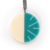 Modernist circular pendant cast in teal  and white resin. Fitted on a 60cm oxidised Sterling silver chain.