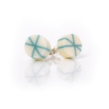 Geometric resin Zazou circle stud earrings cast in white, inlaid with turquoise blue