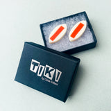 orange and white leaf resin stud earrings presented in Tiki box