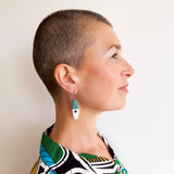 asymmetrical long diamond shaped teal resin earrings worn by model