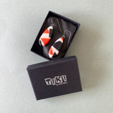 a pair of long diamond shaped earrings presented in Tiki gift box