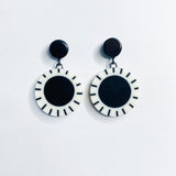 Black and white Dangle Resin Earrings hung on black studs