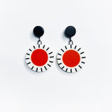 Orange, black and white Dangle Resin Earrings hung on black studs