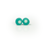 Teal blue resin stud earrings inlaid with a white dot. Fitted with Sterling silver pins.
