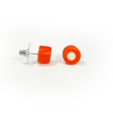 Tangerine orange resin stud earrings inlaid with a white dot. Fitted with Sterling silver pins. View of the plastic earring  back.