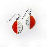 Leaf shaped resin earrings cast in orange and white resin, and inlaid with black polka dots. Fitted with oxidised silver hooks.