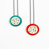 Two necklaces with colorful circular pendants on a white background