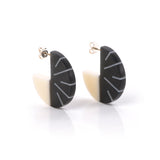 Minimalist disc hoop earrings, handmade from black and white resin. Lightweight and tactile, they are fitted with silver pins and butterfly backs.