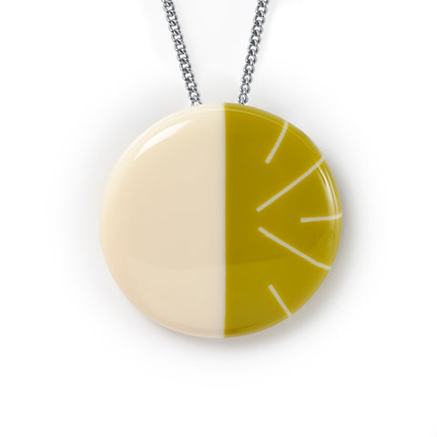 The modernist Lunula pendant is handmade in creamy and mustard green resin. It is inlaid with the beautiful minimalist Lunula stripy design. It hangs on a 70cm long an oxidised Sterling silver chain.