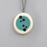 blue and white round resin pendant inlaid with black polka dots