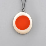 orange and white pebble shaped pendant, reversible, handmade from resin and oxidised Sterling silver