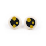 Black and white round resin stud earrings, ornate with mustard green polka dots