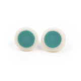 teal and white circular resin stud earrings; a teal centre is surrounded with a creamy white edge; fitted with silver pins