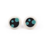 Black and white circular stud earrings ornate with teal blue dots