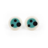 Resin circle stud earrings with a teal blue centre and a white border, decorated with black polka dots
