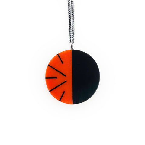 Deep orange and black circular pendant, handmade from resin and silver