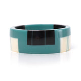 geometric bracelet cuff cast in teal resin, inlaid with black and white stripes