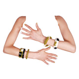 a selection of geometric statement cuff bracelets worn on model's arms