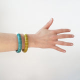 2 modernist resin bracelets worn on model's arm/